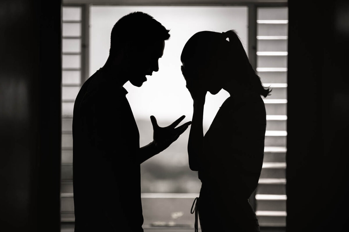 nhappy crying frightened woman and aggressive man quarrelling at