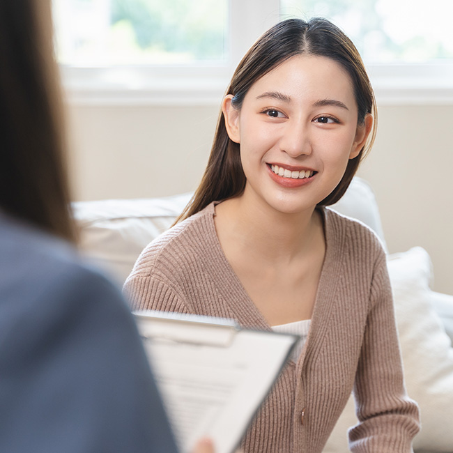 A provider meets with a client in a brightly lit room