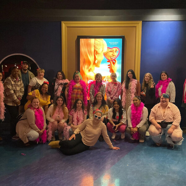 Mindful Support Services staff dress in pink to go see Barbie at a movie theater