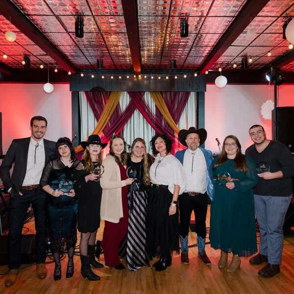 Mindful Support Services leadership pose on the dancefloor, all in western garb