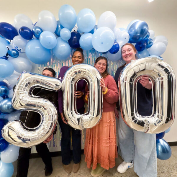 Mindful Therapy Group staff celebrate 500 daily intake record with inflatable letters spelling out 500