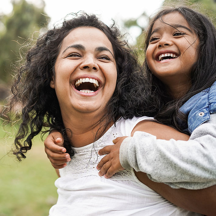 Happy indian mother having fun with her daughter outdoor - Famil