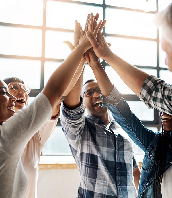 Group high five after helping a client.