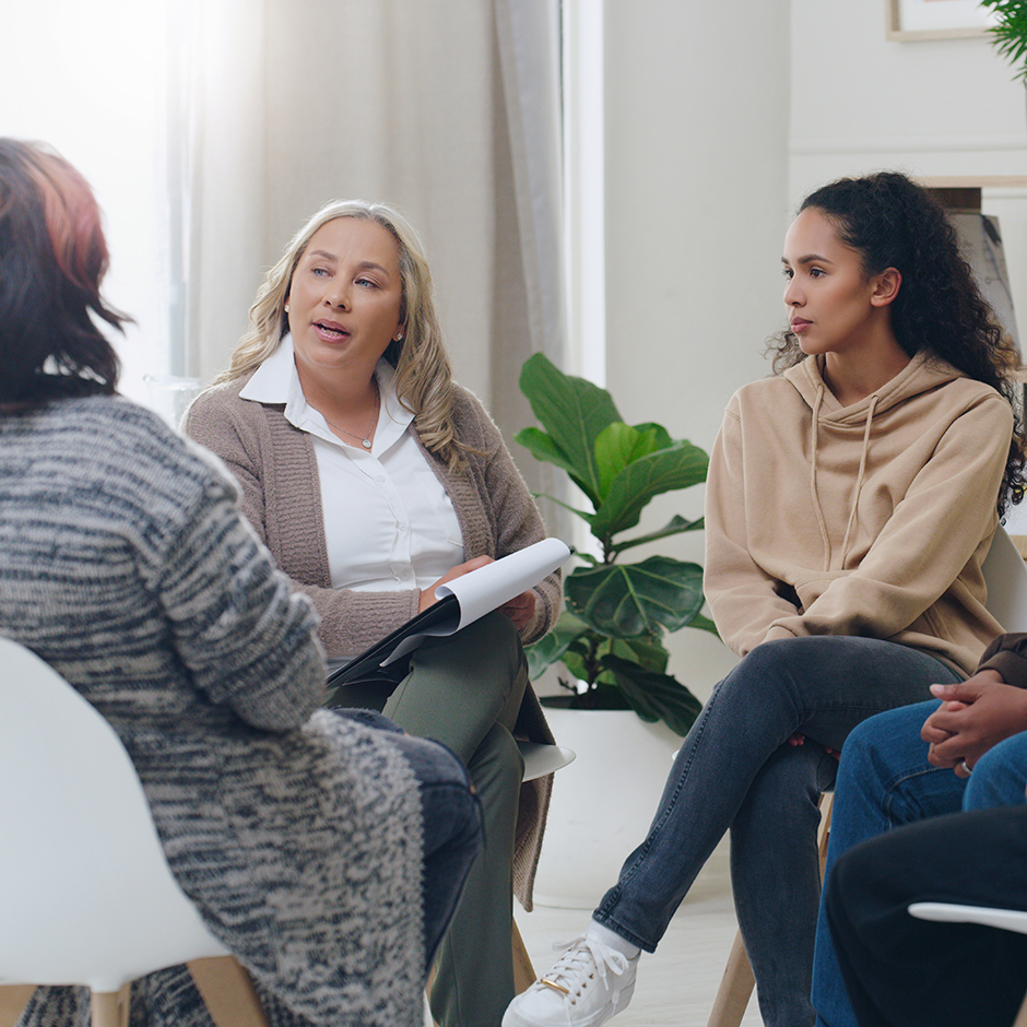 Counseling, group and psychology discussion with group of diversity people in therapy for depression, stress and anxiety. Men and women healing during psychologist meeting talking about mental health
