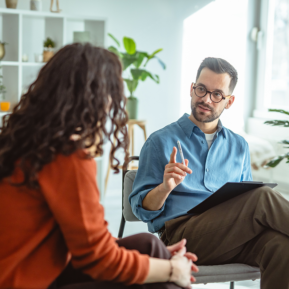 Woman receiving counseling from a male therapist in office