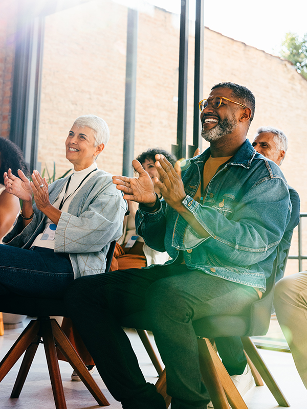 Happy employees clapping after learning about company EAP