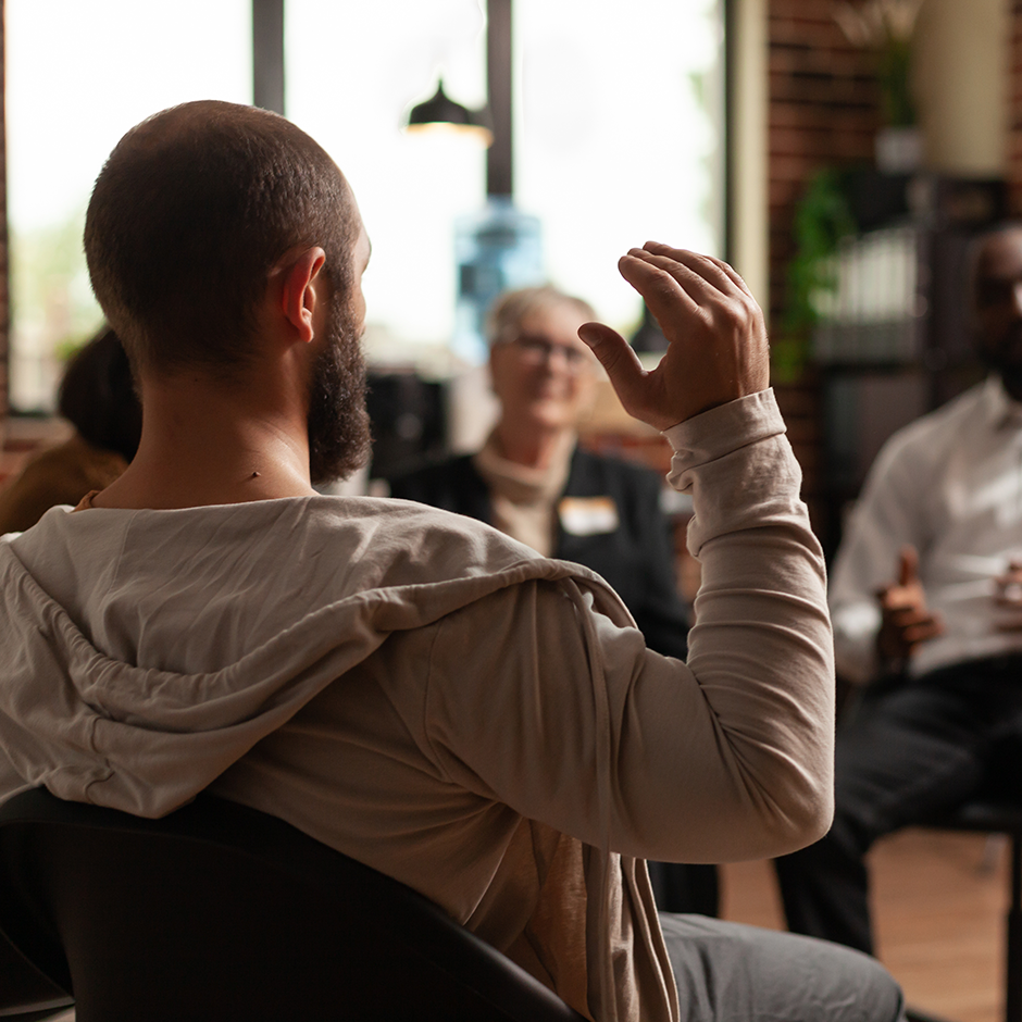 Man with addiction sharing mental health issues with group at aa meeting, talking to therapist. People having conversation about depression and rehabilitation at therapy session.